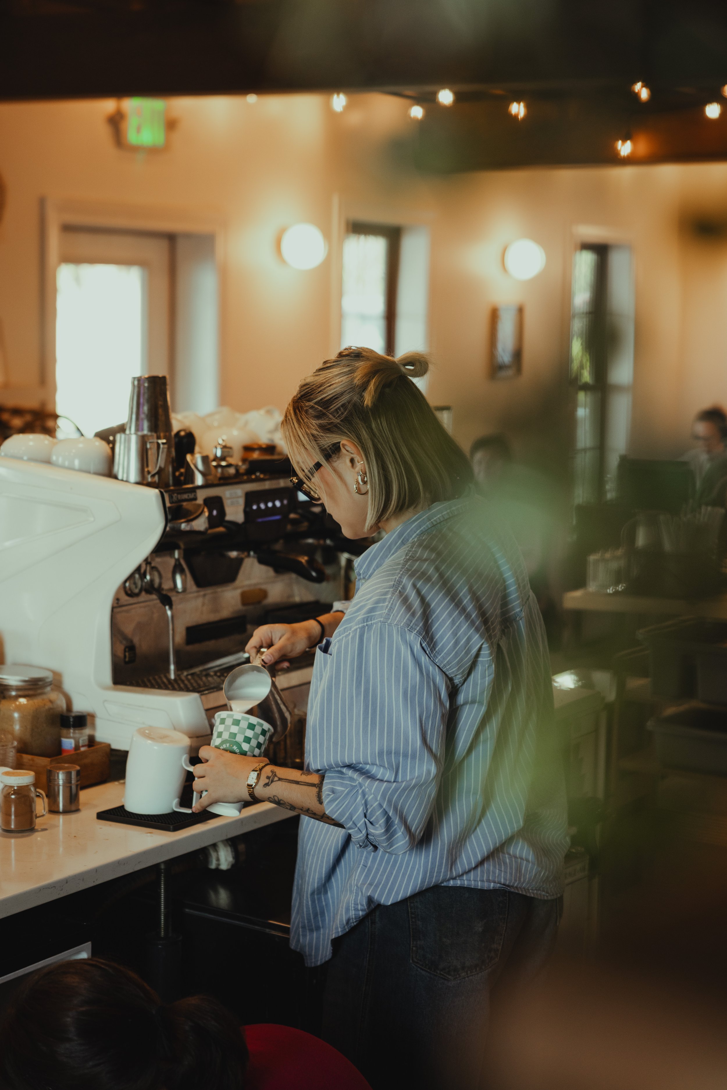 A Honey Moon barista working behind the coffee bar