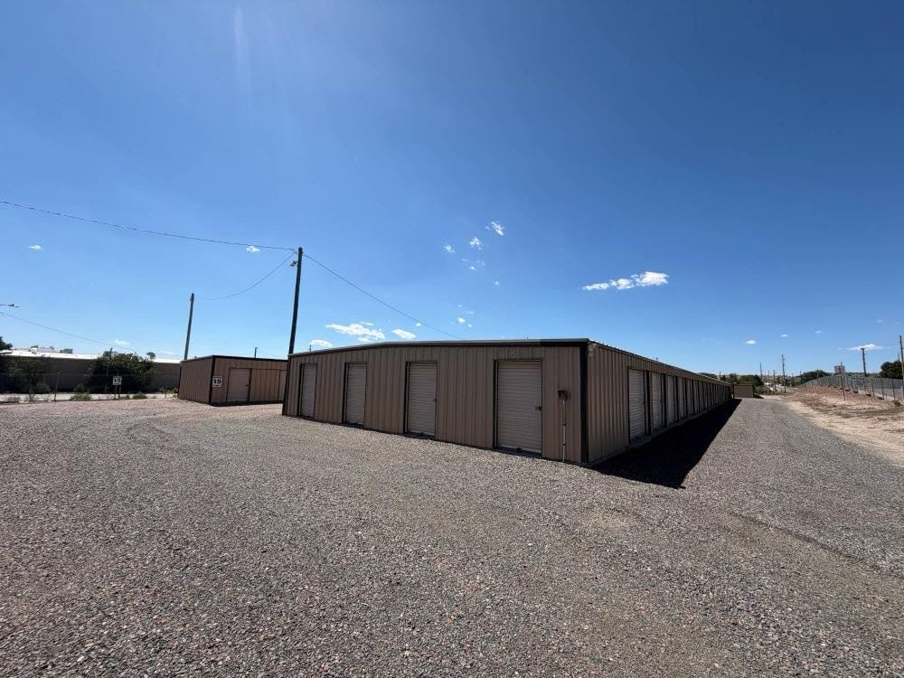 Independently owned self storage facility on a gravel drive at the edge of a small town