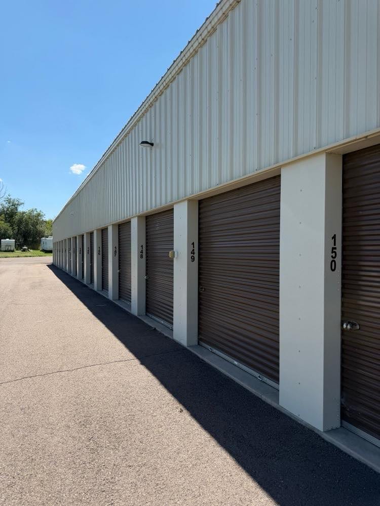 Long row of numbered roll up doors at an independently owned self storage facility